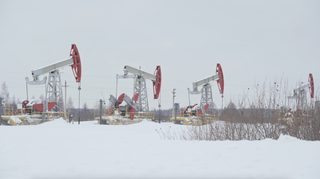 Russian pumpjacks in a winter field.